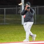 Student Amiel Johnson pointing a camera at a subject.