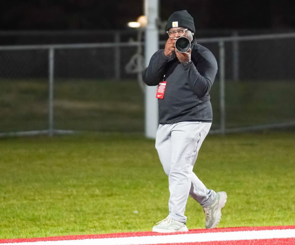 Student Amiel Johnson pointing a camera at a subject. 