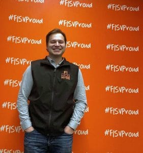 Photo of Blake Tyrell in front of a red Fiserv wall.