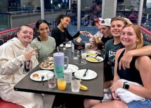 Students at a table in a cafeteria.