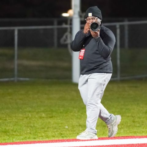 Student Amiel Johnson pointing a camera at a subject.