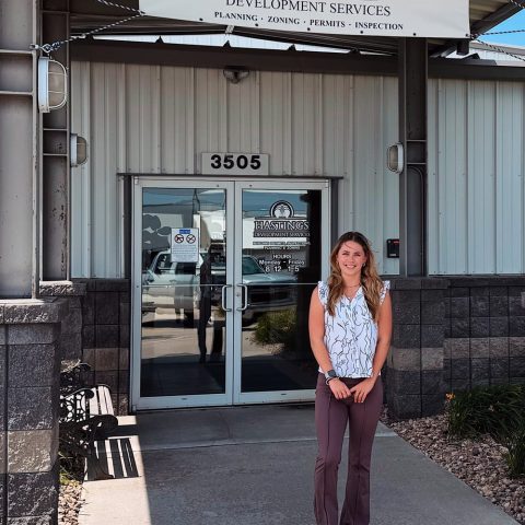 Lily Teeple in front of the City of Hastings Development Services Department building.